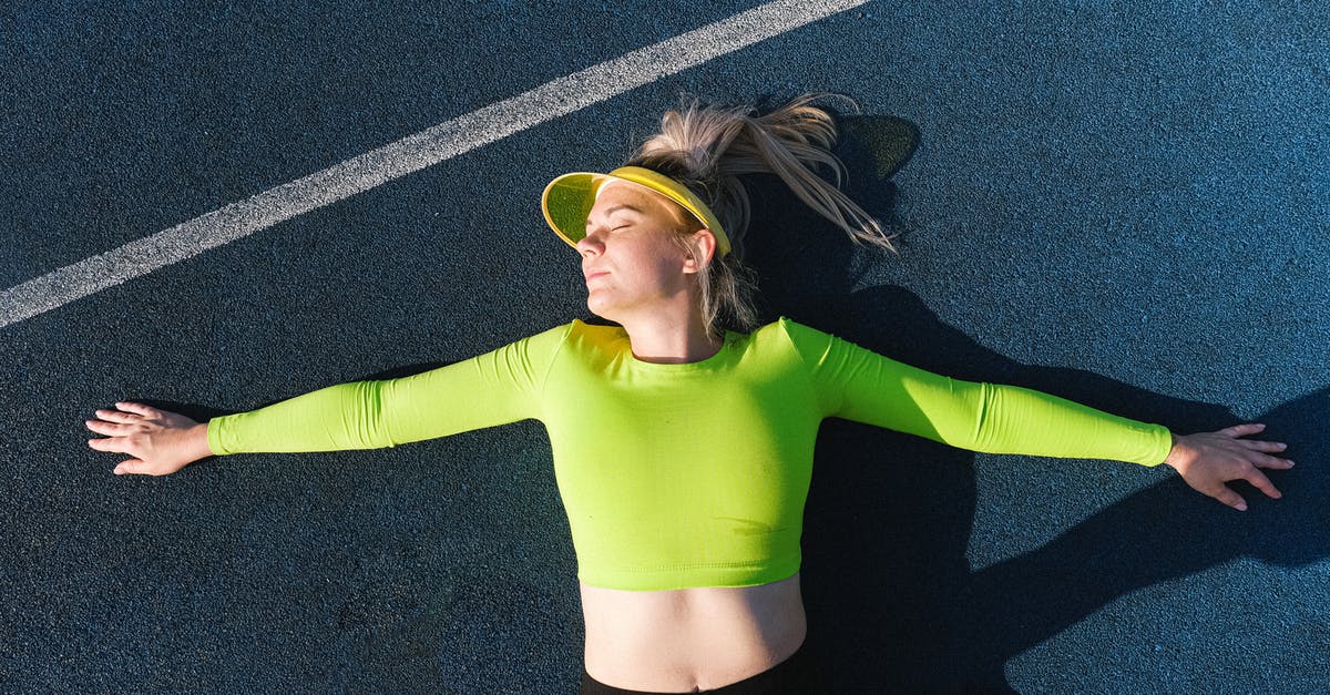 Where is the sun visor? - Relaxed woman lying with outstretched arms