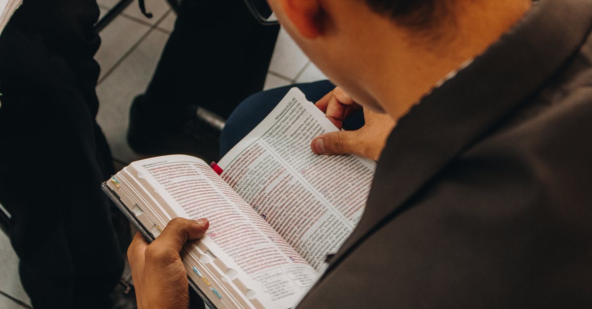 Where is the third data volume for The Frightened Engineer? - High angle back view of crop unrecognizable male in casual wear and eyeglasses sitting on bench and reading book in public place