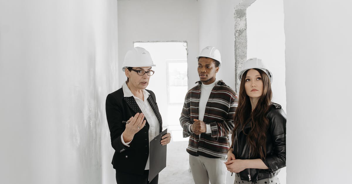 Where to get the hammer suit - Man in Black Suit Standing Beside Woman in Black and Brown Stripe Long Sleeve Shirt