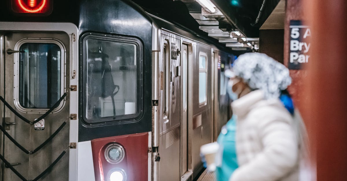 Where to go next if my first move reveals a number? - Unrecognisable female in medical uniform coat and with paper cup waiting for train arriving on subway platform