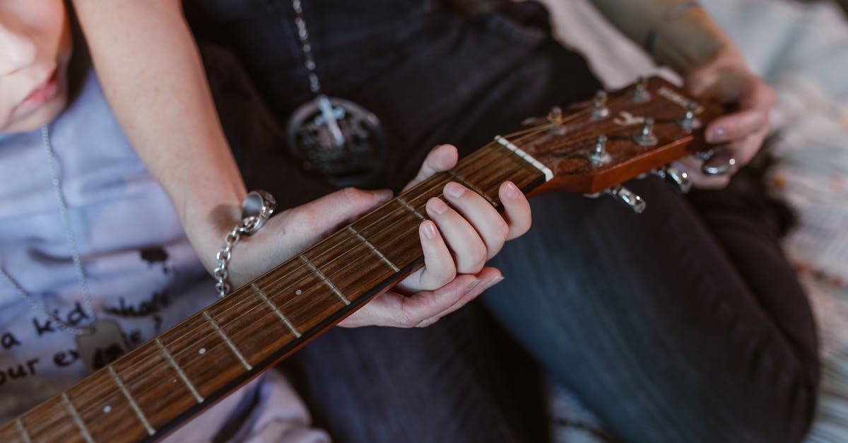 Which gun does the Double Duty talent affect? - Anonymous young mother with little son practicing on guitar at home