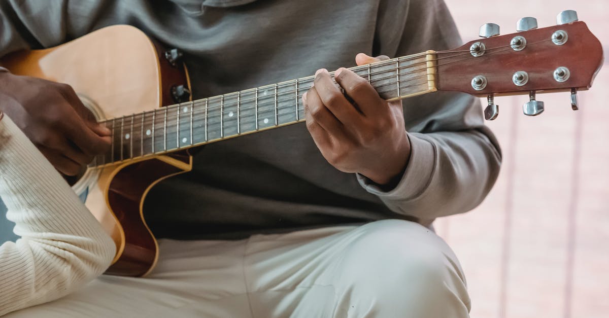 Which gun does the Double Duty talent affect? - Black man playing guitar while girlfriend listening