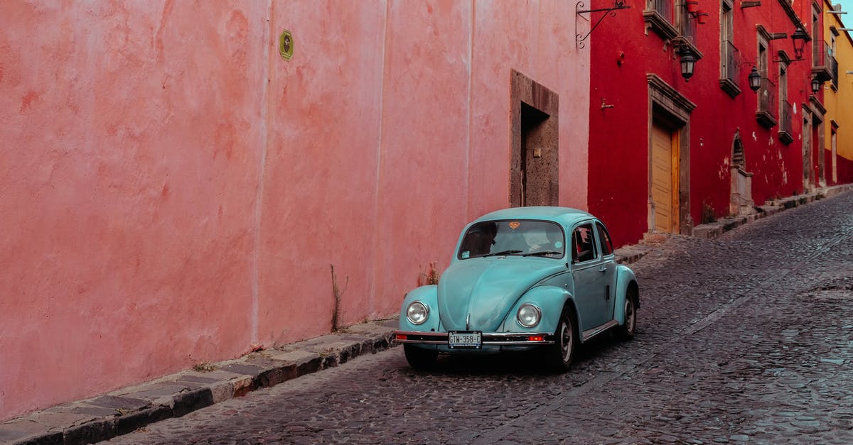 Which heroes move the fastest along the ground? - Turquoise Buggy Moving Along Street with Pink and Red Buildings