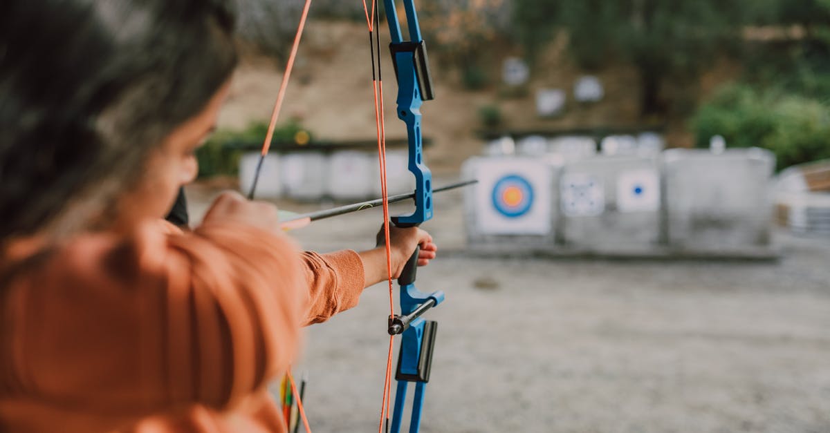 Which is the better archer? - A Person Holding an Archery Bow