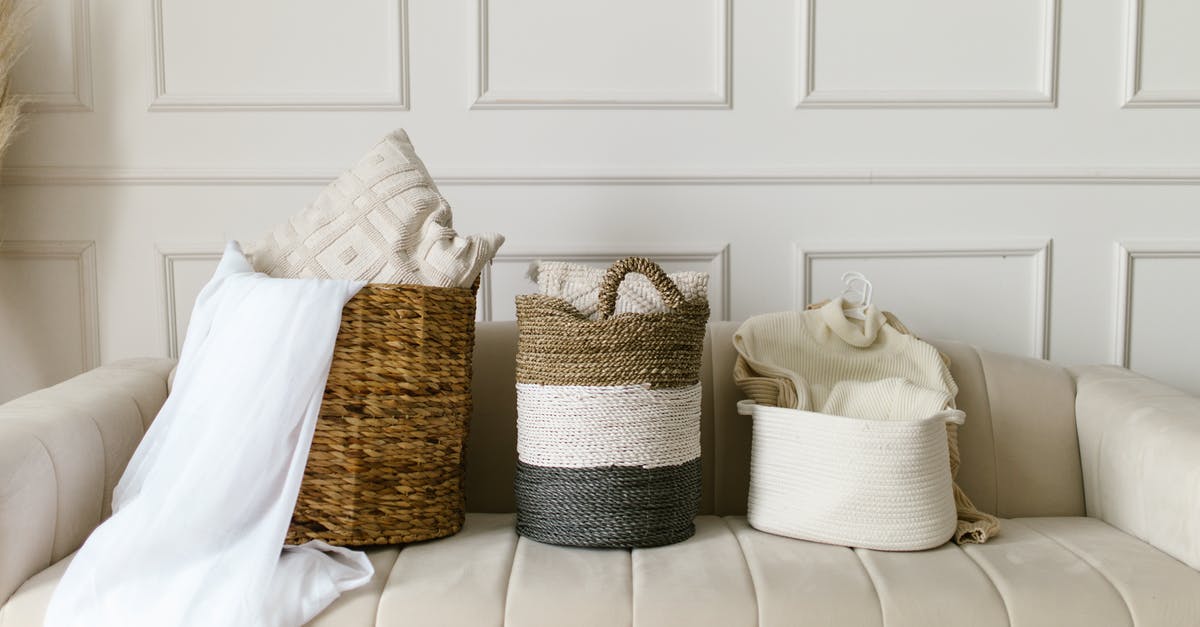 Which items have the highest enchantment values? - White and Brown Wicker Baskets on White Couch