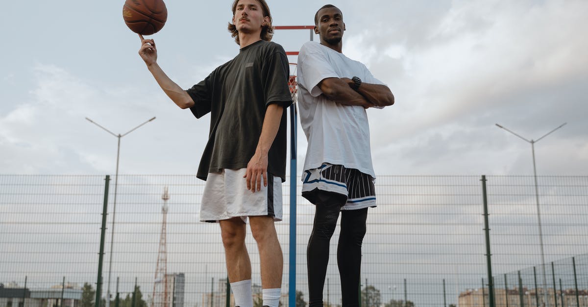 Who is the player? - Man and Woman Standing on Basketball Court