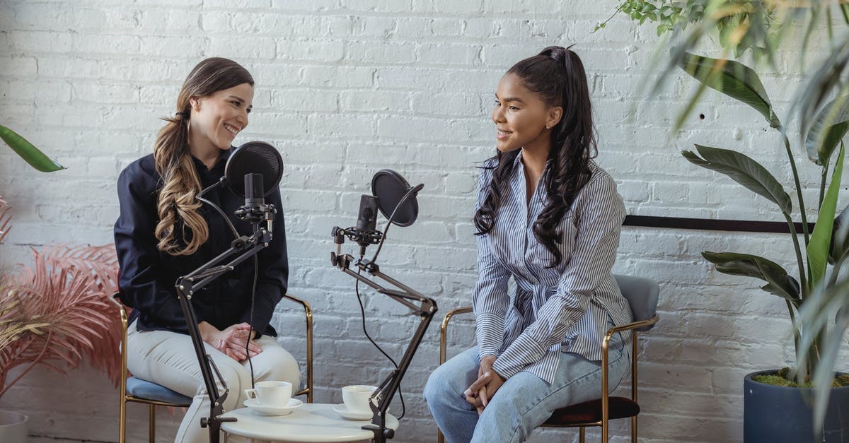 Who was the voice actress for GLaDOS? - Diverse women communicating while recording voice in studio with white brick walls in daytime