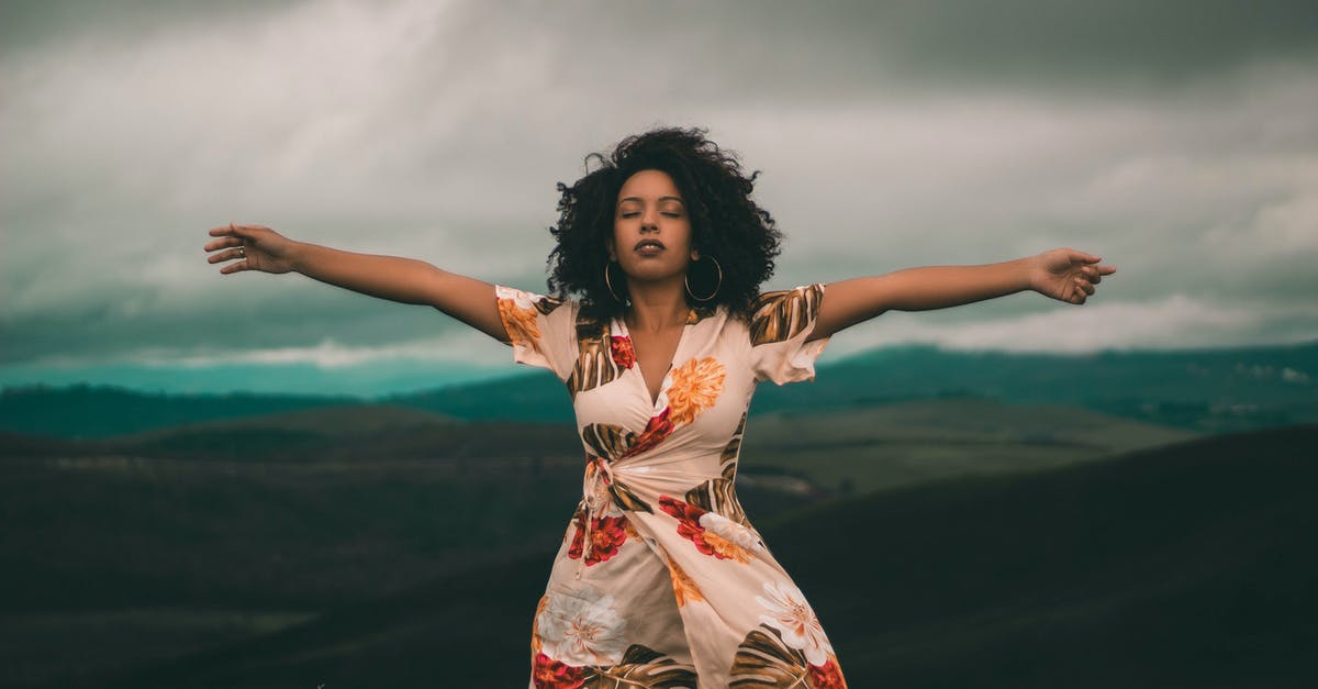 Why am I feeling funky? - Woman in White and Red Floral Dress Standing on Green Grass Field