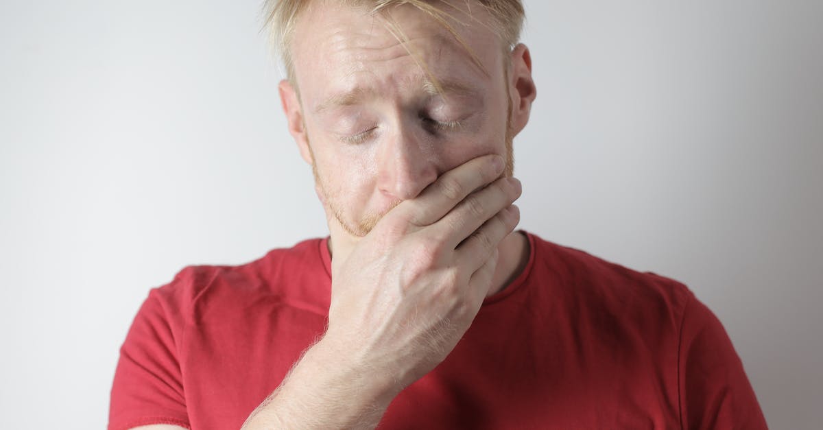 Why am I having trouble finding a legit copy of Pokémon Emerald? [closed] - Mature man in red t shirt being in shock after getting news standing with closed eyes near gray wall in room