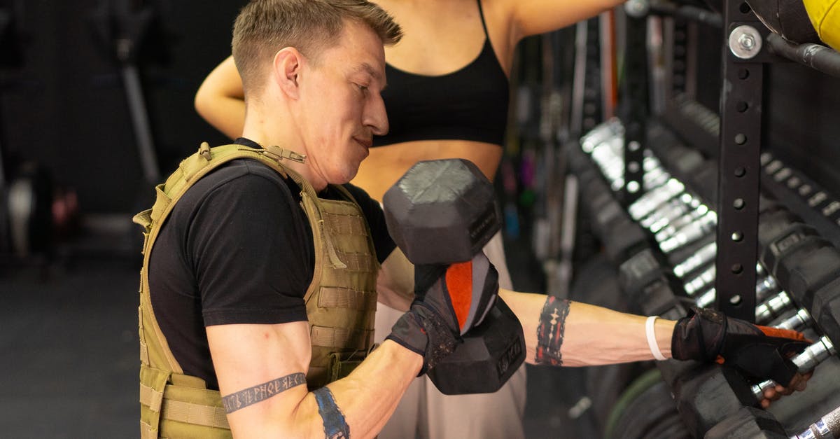 Why am I only getting 2 karma for 50 kittens? - Side View of a Man in a Weighted Vest Holding a Dumbbell