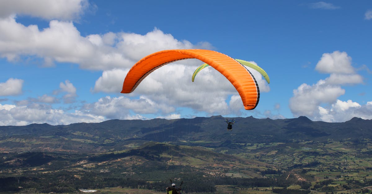 Why are parachutes so useless? - Person Paragliding with Orange Parachute