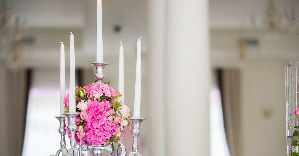 Why are the hidden items in Fire Red/Leaf Green sometimes absent? - Flaming wax candle in metal candelabrum decorated with ball of flowers against blurred background of light room