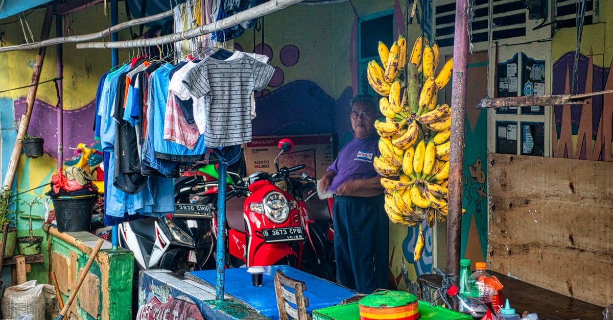 Why are there unreachable bananas? - Yellow Banana Fruit on Green Plastic Basket