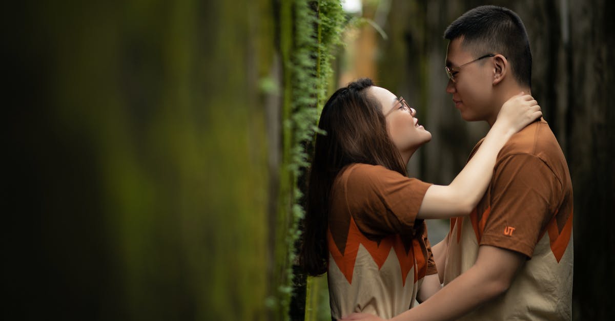 Why batches of same items are not next to each other? - Loving couple embracing near wall with moss