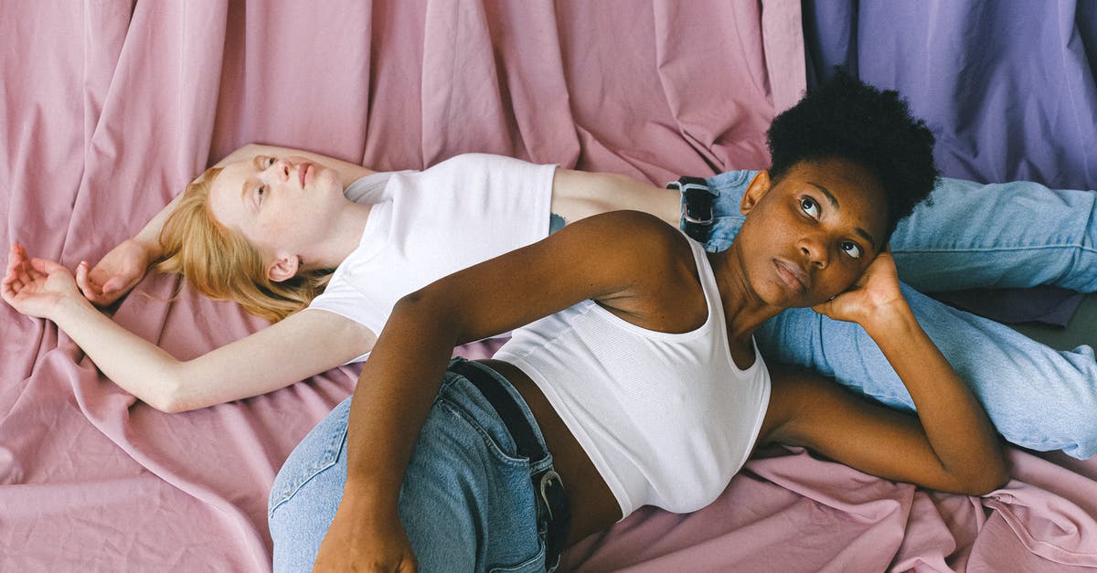 Why can't I grind my three Purple Shields? - Interracial Women Lying Down in Opposite Directions on Pink Textile