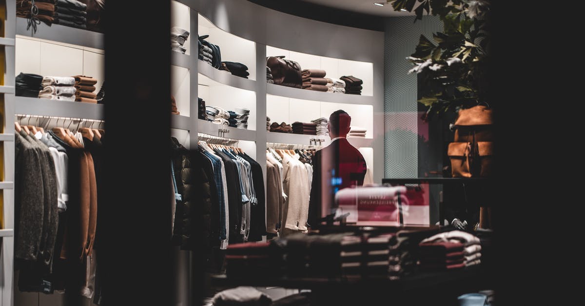 Why can't I trade my Swampert to X/Y? - Back view of faceless elegant male customer in suit choosing new clothes while standing near wardrobe in modern fashion boutique