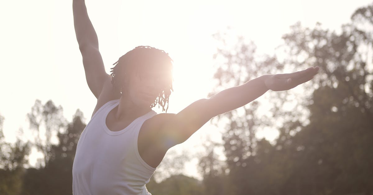 Why can't I Triport from my Stronghold back to Luterra? - Sportsman in undershirt raising arms while doing exercises in sunny day in park