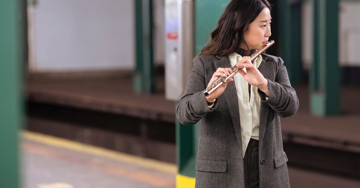 Why can't I tune the radio to the Poké Flute station? - Asian woman in suit playing flute in subway