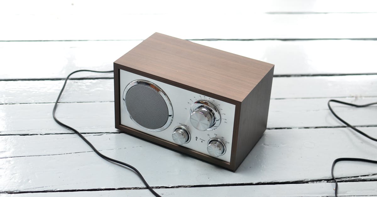 Why can't I tune the radio to the Poké Flute station? - From above of vintage styled FM radio with wooden case and steel buttons placed on white lumber table