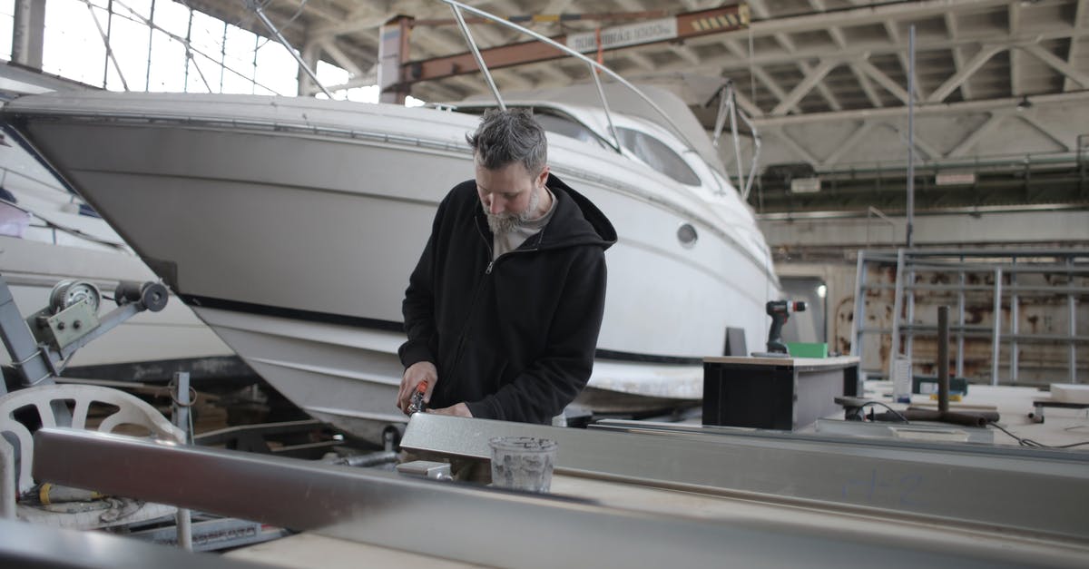 Why can't I use a Robot Workbench at Boston Airport Ruins? - Concentrated bearded adult workman in casual wear working with metal detail near boat in garage Why can't I use a Robot Workbench at Boston Airport Ruins? - Concentrated bearded adult workman in casual wear working with metal detail near boat in garage
