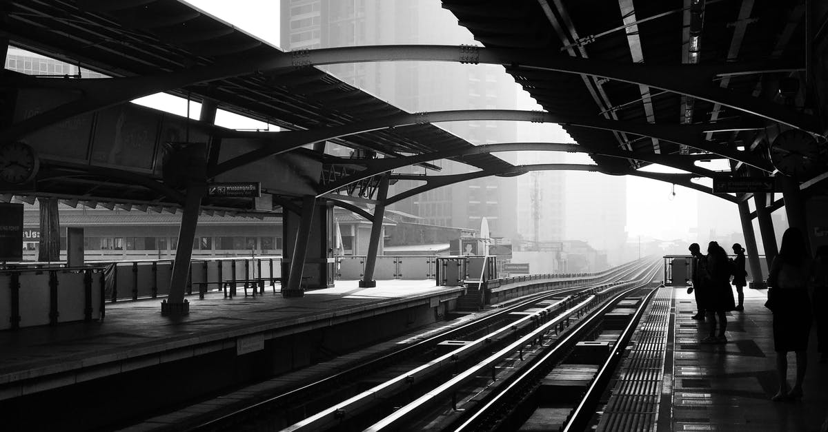 Why did my train choose the blocked path at the junction? - Silhouettes of anonymous people standing on railway platform