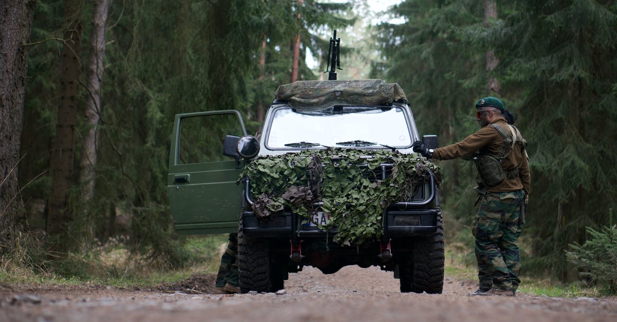 Why do bolt-action sniper rifles occasionally not kill in one hit? - Army Official  Standing Beside Green Off road Car