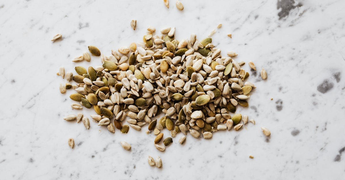 Why does the move Leech Seed have so many odd quirks? - From above of oval shaped dried pumpkin seeds with green and gray shell spilled on marble surface with spots