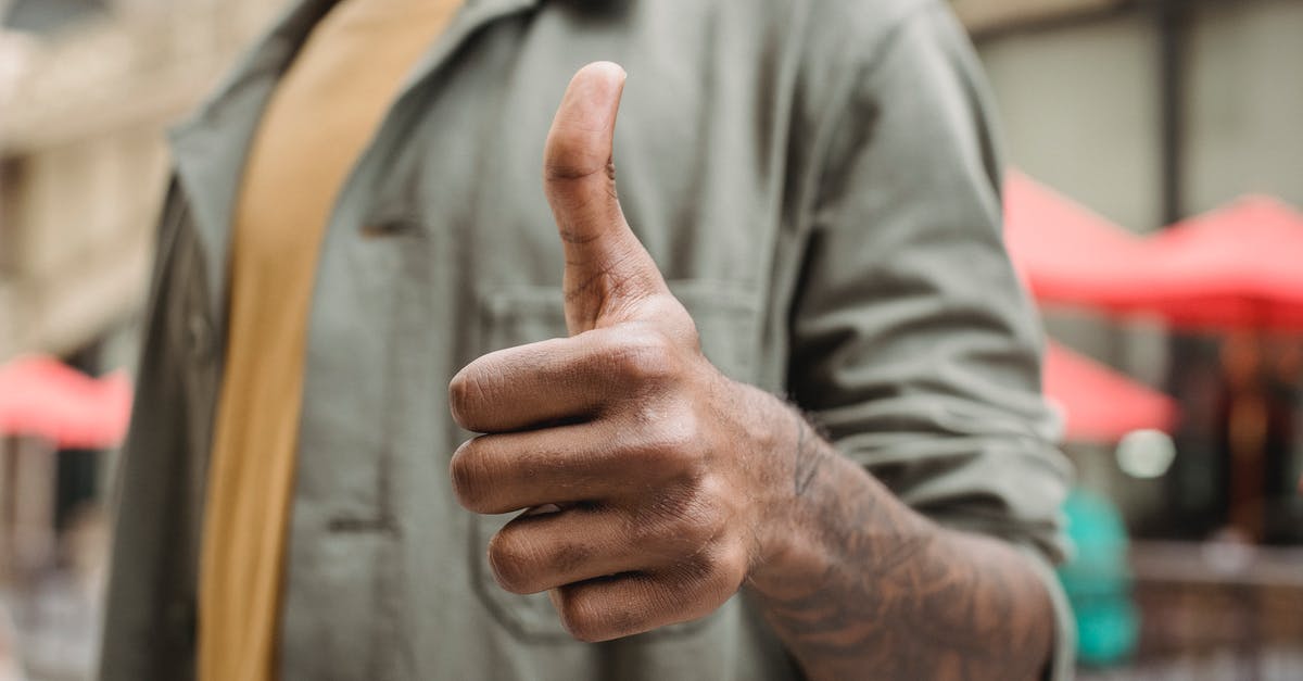 Why does this Wizard build recommend Physical/Lightning Resistance? - Crop faceless young black male in casual outfit standing on city street and showing thumb up gesture