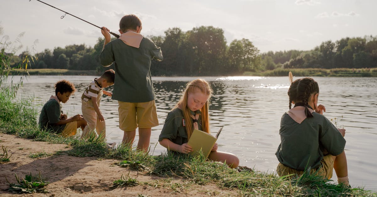 Why is my sword a fishing rod? - Man in Gray Shirt Sitting Beside Girl in Yellow Shirt and Black Pants Sitting on Brown