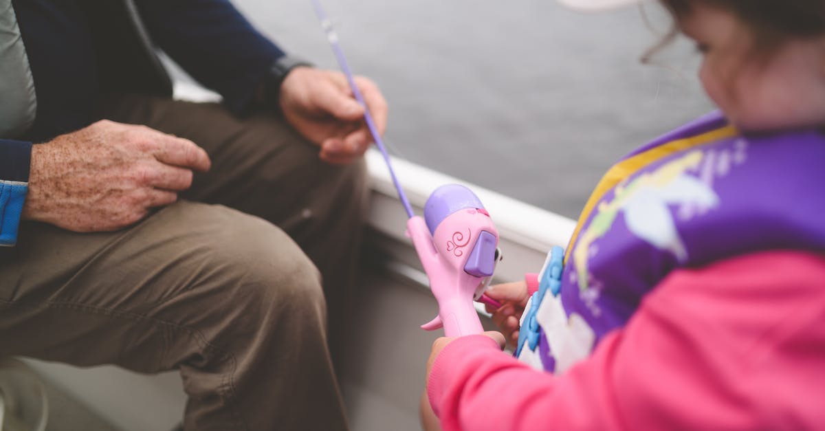 Why is my sword a fishing rod? - A Girl Holding a Pink Fishing Rod Toy 