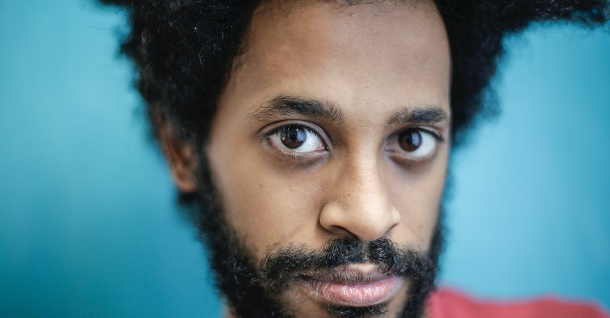 Why wasn't this character killed immediately? - Headshot of confident ethnic man on blue background