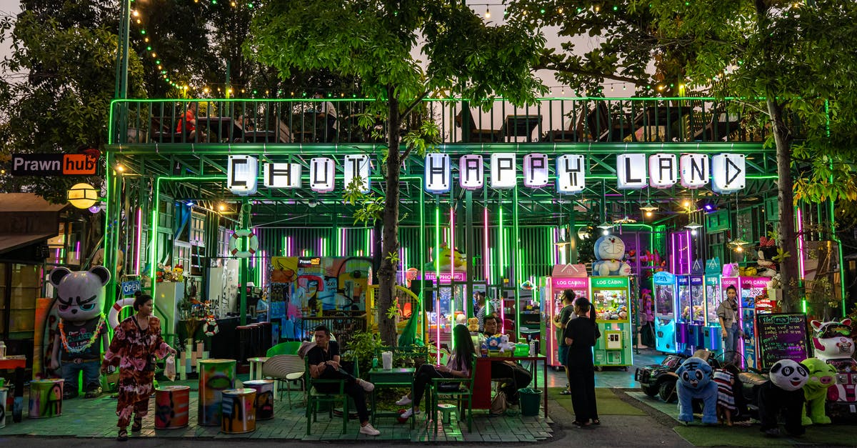 Why were arcade machines so big? - People in an Arcade Beside Trees