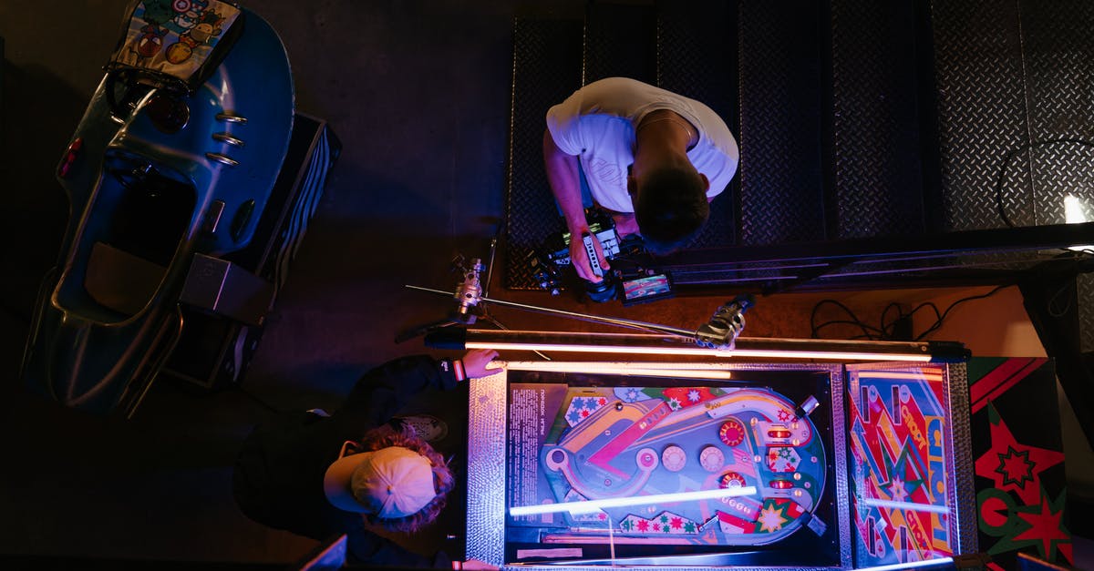 Why were arcade machines so big? - Man in White T-shirt Playing Arcade Game