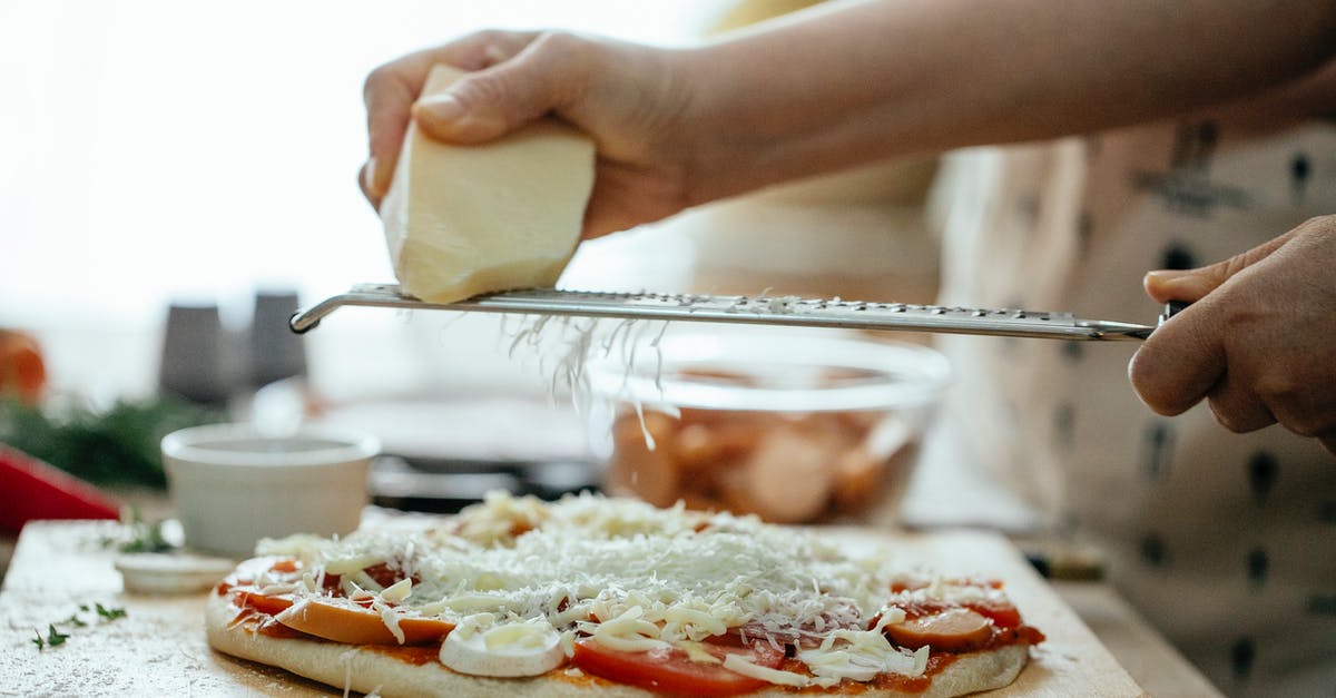 Why won't attribute modifiers add up on my armor? - Side view of crop unrecognizable person grating piece of hard cheese on palatable homemade pizza in kitchen at daytime