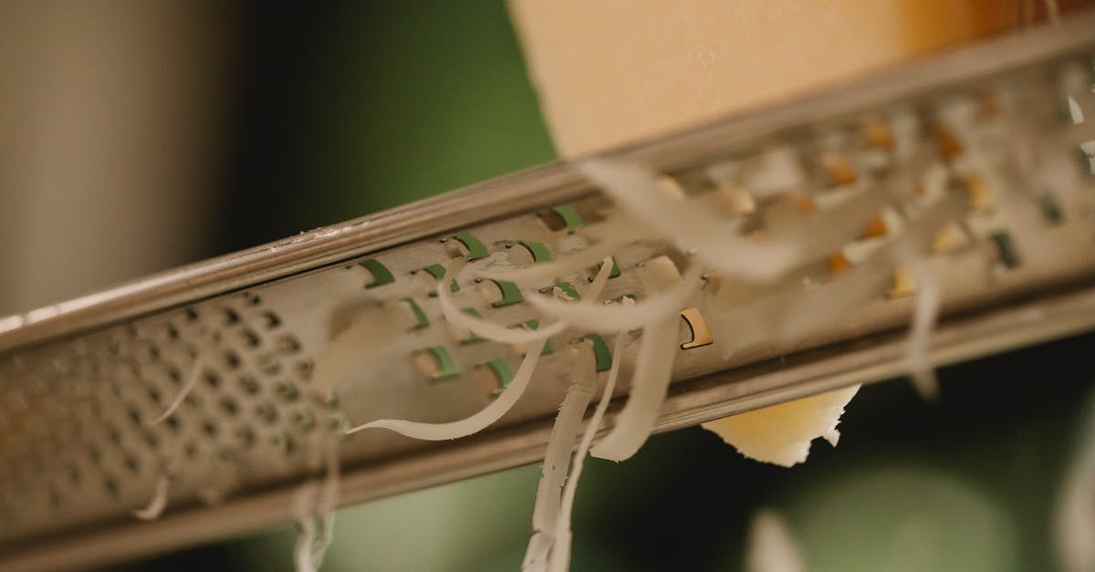 Why won't attribute modifiers add up on my armor? - Closeup of tasty hard cheese grating on narrow stainless grater against blurred kitchen background