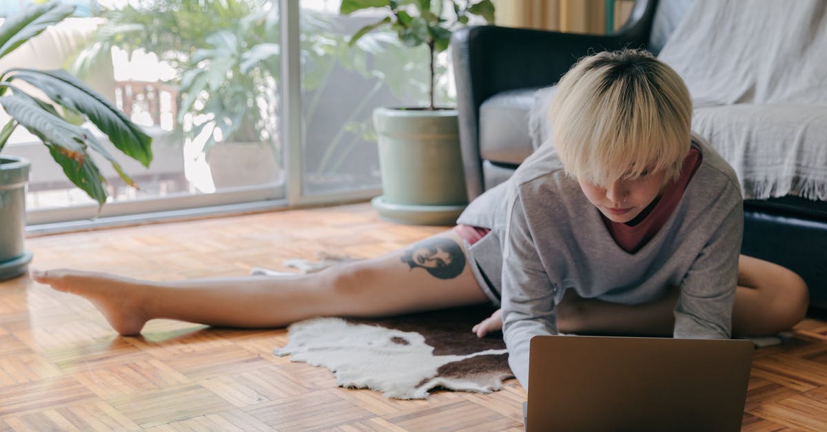 Widescreen letterbox upscale and vertical-only stretch on ACIV - Focused woman using laptop on floor