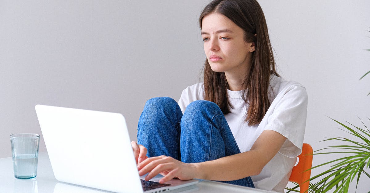 Wii remotes won't sync to Wii - Woman in White T-shirt and Blue Denim Jeans Working on a Laptop