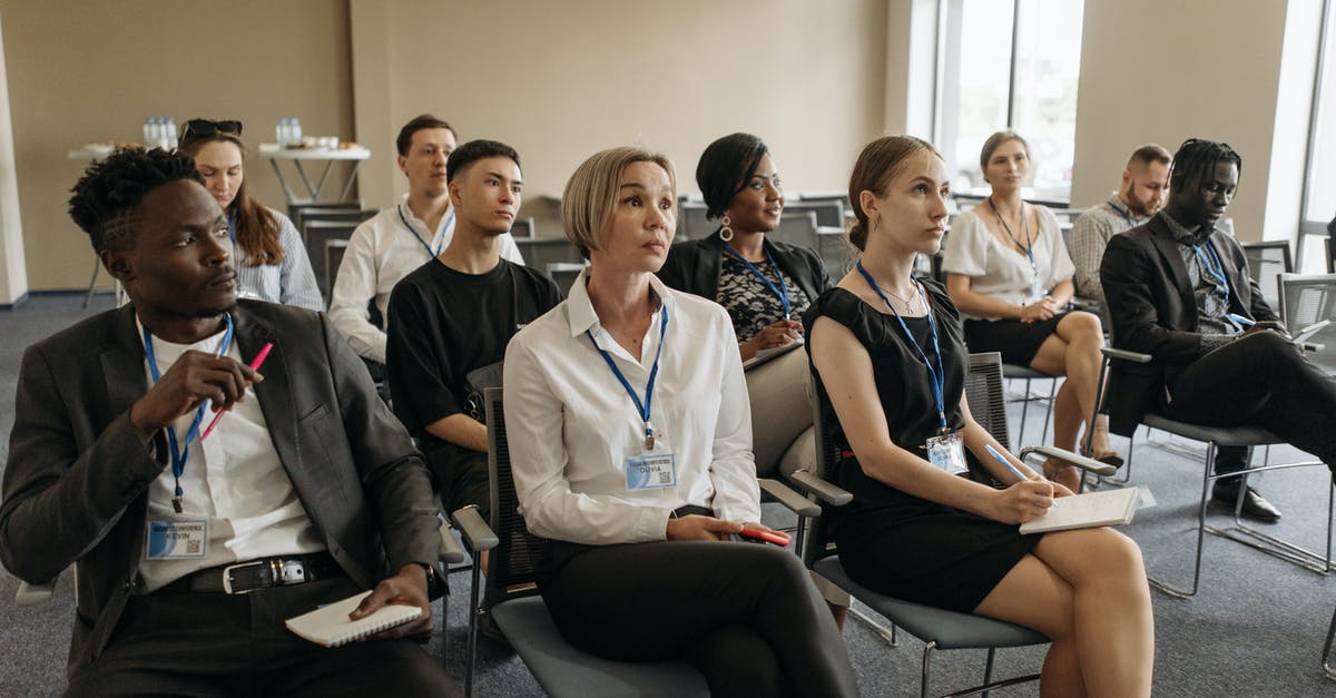 Will badges I obtain reappear in the panel? - A Group of People with Badges Sitting on Chairs