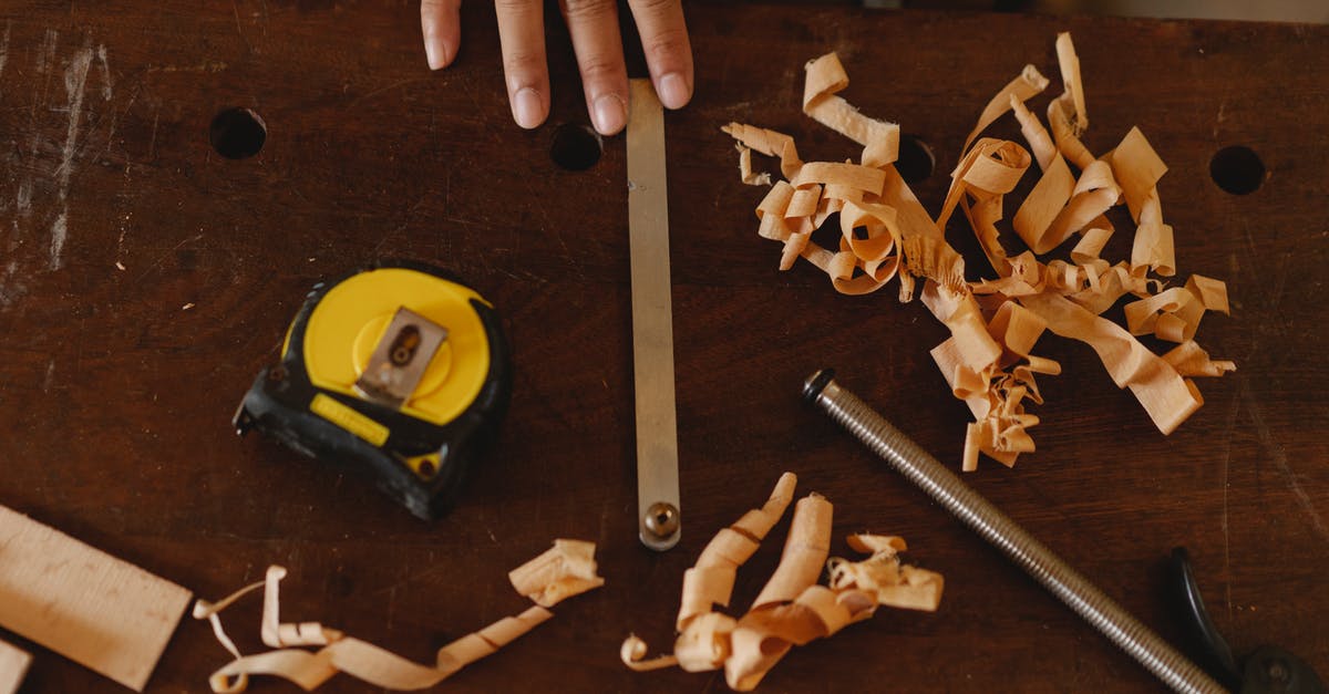 Will master codes from different cheat devices cause a conflict? - From above of crop anonymous woodworker with assorted instruments and wooden shavings in workshop