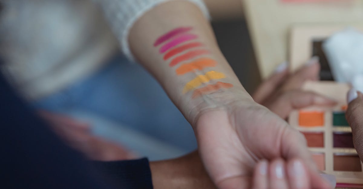 Will master codes from different cheat devices cause a conflict? - Faceless women applying multicolored eyeshadows on wrist for testing