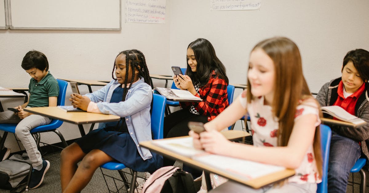 Will using Fortune allow me to collect more food? - Students Sitting Inside the Classroom While Using Their Smartphone