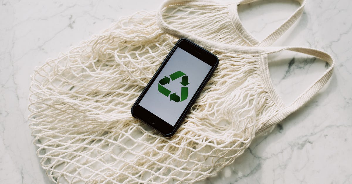 Witcher 3 DPS reducing - Overhead of smartphone with simple recycling sign on screen placed on white eco friendly mesh bag on marble table in room Witcher 3 DPS reducing - Overhead of smartphone with simple recycling sign on screen placed on white eco friendly mesh bag on marble table in room