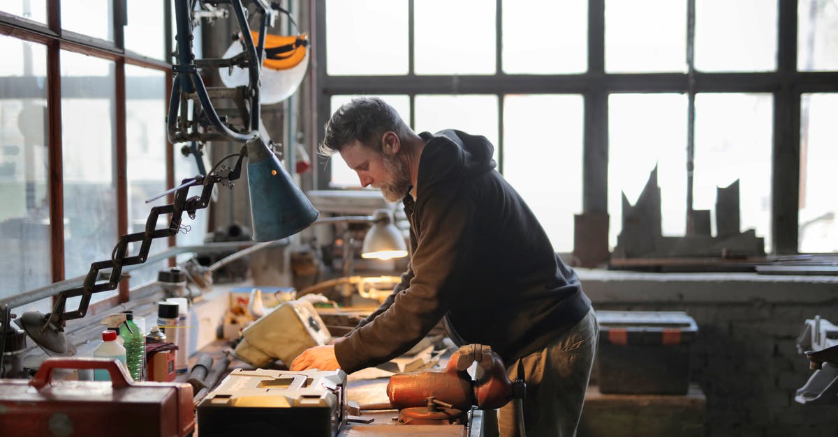 Workshop - not producing anything at all - Photo of Man Wearing Black Jacket Standing Near Table