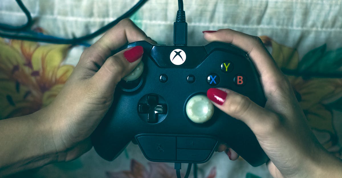 Xbox 360 Steering Wheel on Xbox One - Person Holding Microsoft Xbox One Controller